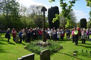 Roger explains the history of the church, the yew trees and the features and ancient sites within the churchyard. Here he is explaining the historical significance of the 'gathering cross'.